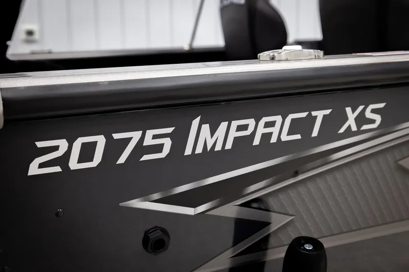 Slide: The Image of 2026 Lund 2075 Impact XS boat model nameplate in close-up view. - 60