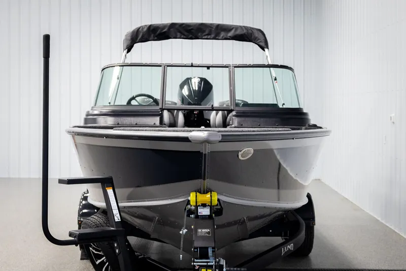 Slide: The Image of 2026 Lund 2075 Impact XS boat in showroom, front view with trailer. - 7