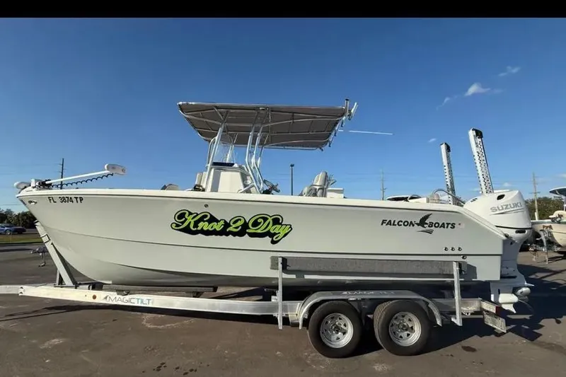 The Image of 2023 Falcon Boats F22 on trailer, named "Knot 2 Day," with Suzuki outboard motor. - 0