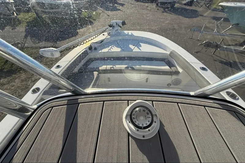 Slide: The Image of 2023 Falcon Boats F22 deck view with compass and seating area. - 11