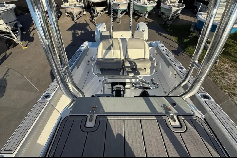 Slide: The Image of 2023 Falcon Boats F22 interior with dual seats and steering wheel, surrounded by other boats. - 13