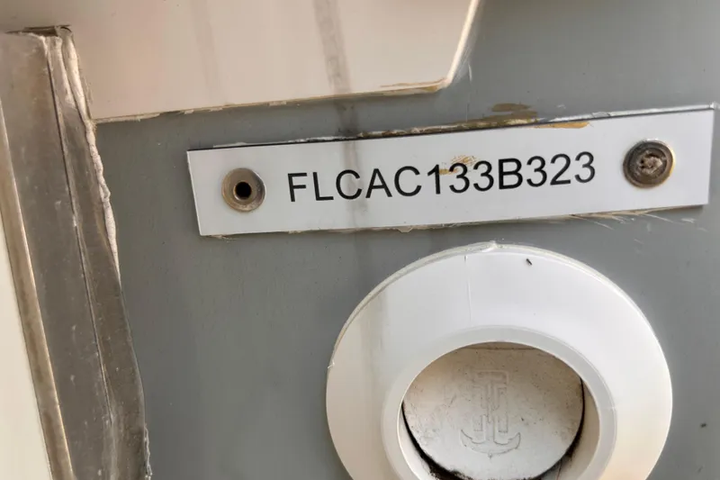 Slide: The Image of 2023 Falcon Boats F22 hull identification number, FLCAC133B323, on a metal plate. - 14