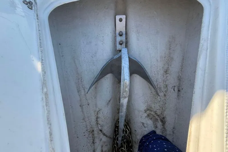 Slide: The Image of Anchor compartment of 2023 Falcon Boats F22 with metal anchor and chain. - 17