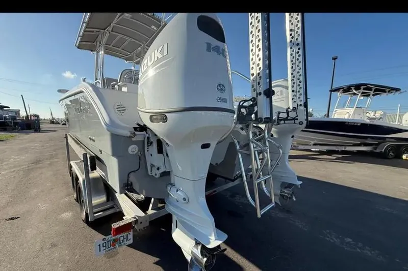 Slide: The Image of 2023 Falcon Boats F22 with Suzuki outboard motor, parked on a trailer. - 26