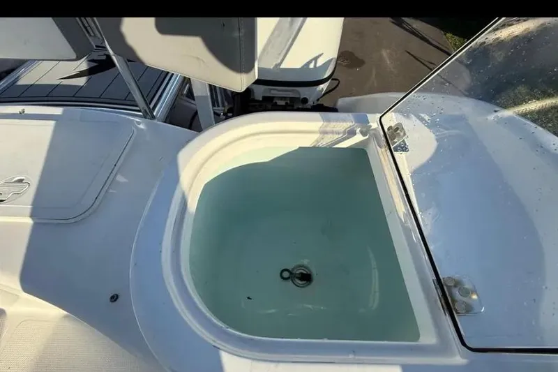 Slide: The Image of 2023 Falcon Boats F22 livewell with open lid, filled with water. - 31