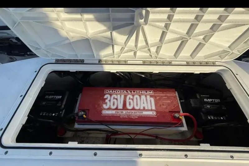 Slide: The Image of 2023 Falcon Boats F22 with Dakota Lithium 36V 60Ah battery in storage compartment. - 32