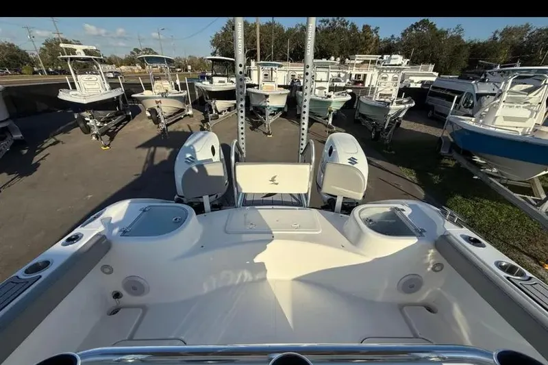 Slide: The Image of 2023 Falcon Boats F22, rear view, showcasing dual engines and spacious deck at a marina. - 33