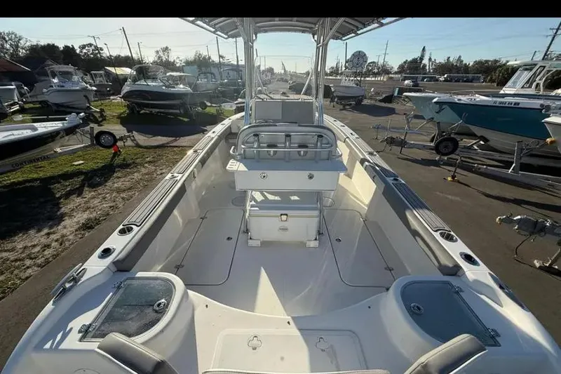 Slide: The Image of 2023 Falcon Boats F22, spacious interior, parked among other boats in a marina. - 34