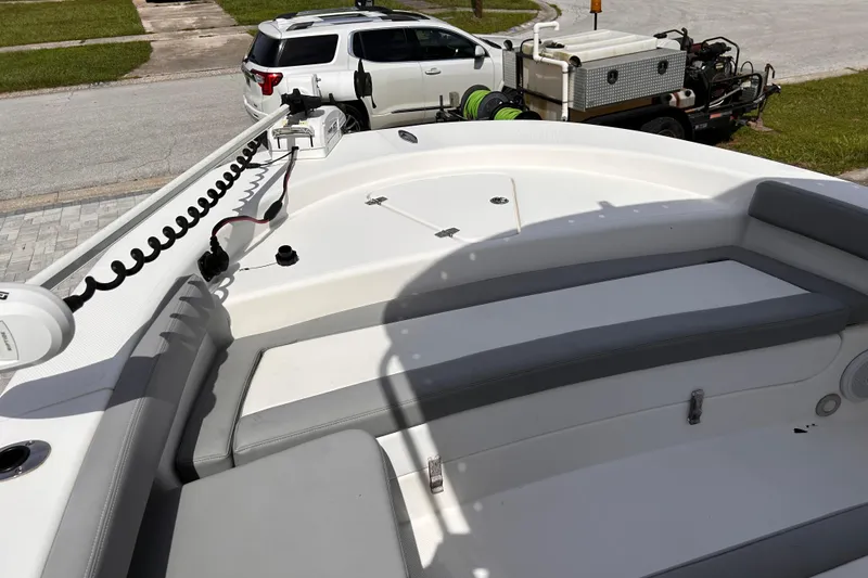 Slide: The Image of 2023 Falcon Boats F22 interior with seating and equipment, parked in a residential area. - 9