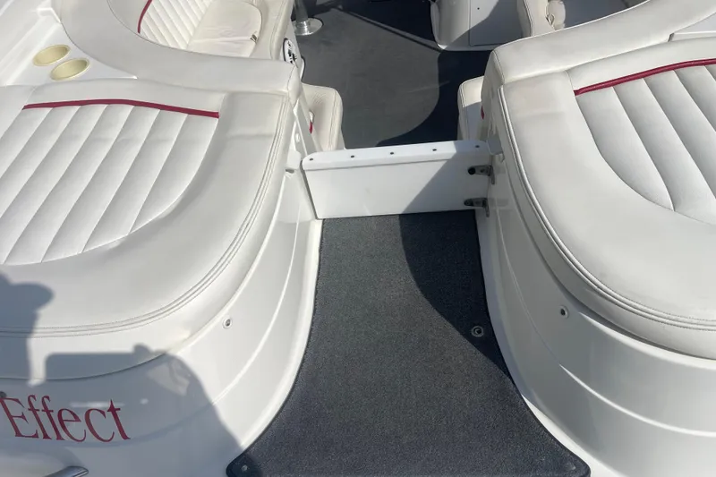 Slide: The Image of 2004 Cobalt 282 boat interior with white cushioned seating and red accents. - 15