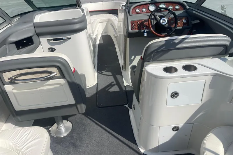 Slide: The Image of Interior of a 2004 Cobalt 282 boat featuring steering wheel and seating area. - 16