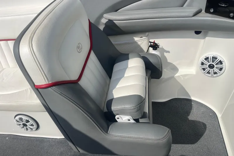 Slide: The Image of 2004 Cobalt 282 boat interior with gray and white seating, speaker, and red trim. - 18