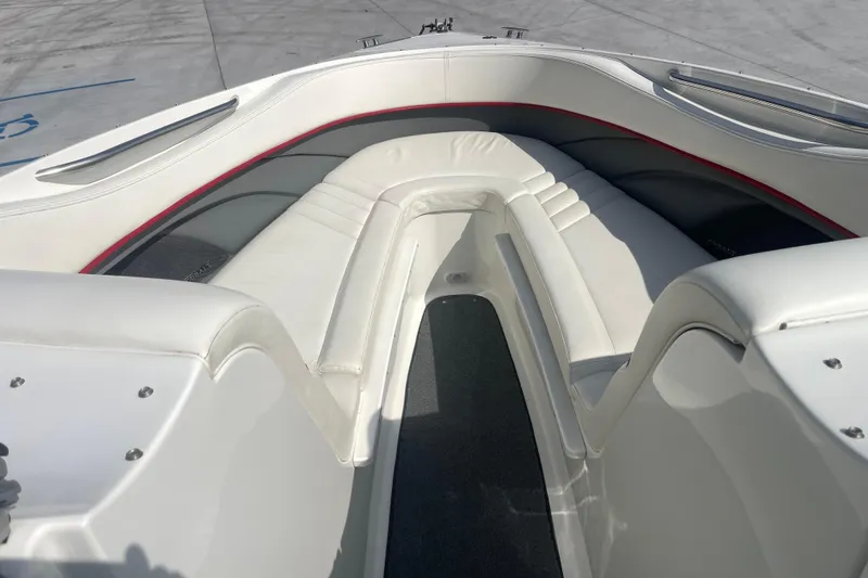 Slide: The Image of 2004 Cobalt 282 boat interior with white leather seating and red accents. - 20