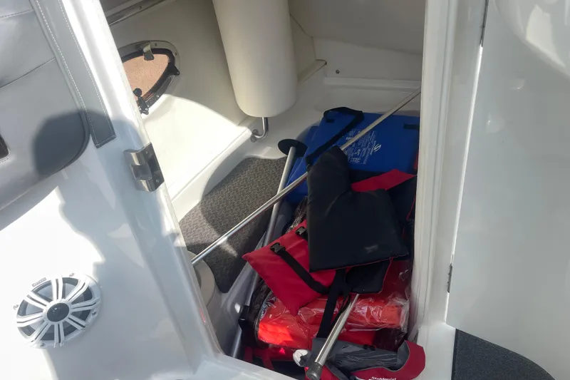 Slide: The Image of Storage compartment in a 2004 Cobalt 282 boat with life jackets and equipment. - 23