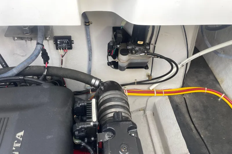 Slide: The Image of Engine compartment of a 2004 Cobalt 282 boat, featuring Volvo Penta components. - 28