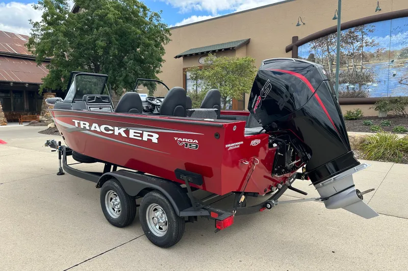 Slide: The Image of 2026 Tracker Targa V-19 Combo boat on trailer, side view, beige color. - 2