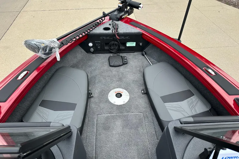 Slide: The Image of 2026 Tracker Targa V-19 Combo boat interior with gray seating and red trim. - 4