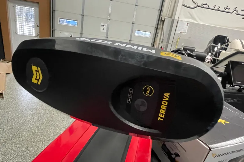 Slide: The Image of 2026 Tracker Targa V-19 Combo boat interior with open storage compartment and carpeted flooring. - 16