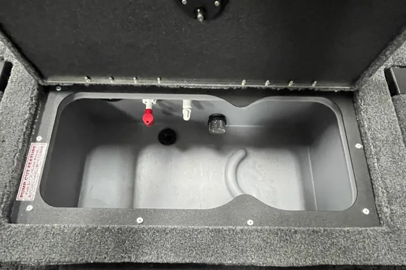 Slide: The Image of 2026 Tracker Targa V-19 Combo boat storage compartment with organized tackle boxes. - 18