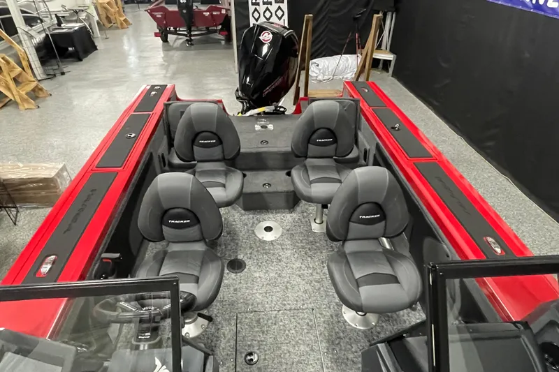 Slide: The Image of 2026 Tracker Targa V-19 Combo boat interior with four seats and red accents. - 7