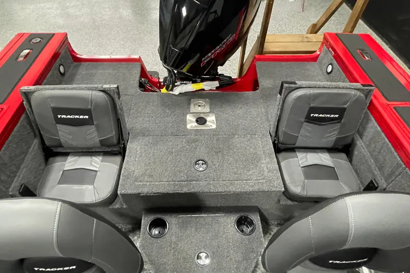 Slide: The Image of 2026 Tracker Targa V-19 Combo boat interior with gray seating and red accents. - 8