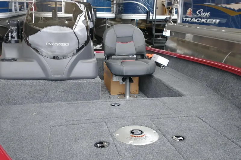 Slide: The Image of 2026 Tracker Super Guide V-16 SC boat interior with seating and console. - 3