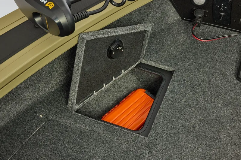 Slide: The Image of 2026 Tracker Targa V-19 Combo boat storage compartment with orange case inside. - 14