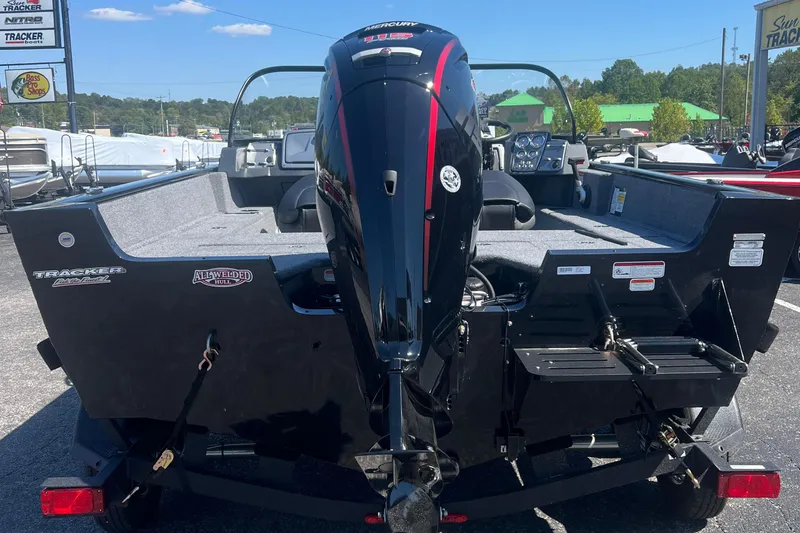 Slide: The Image of 2026 Tracker Pro Guide V-175 Combo boat with Mercury engine, parked outdoors. - 5
