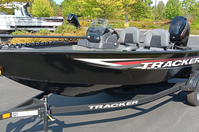 The Image of 2026 Tracker Super Guide V-16 SC boat on trailer, parked outdoors. - 0