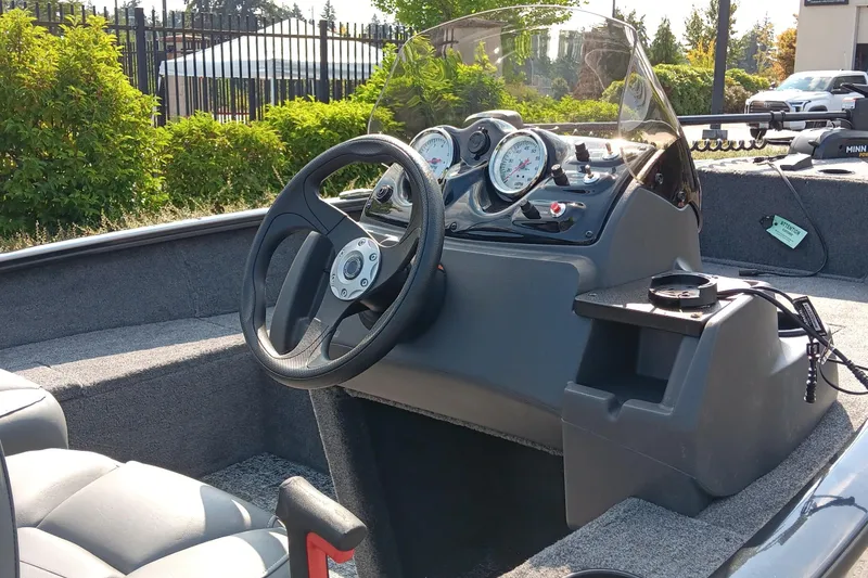 Slide: The Image of 2026 Tracker Super Guide V-16 SC boat dashboard with steering wheel and gauges. - 2