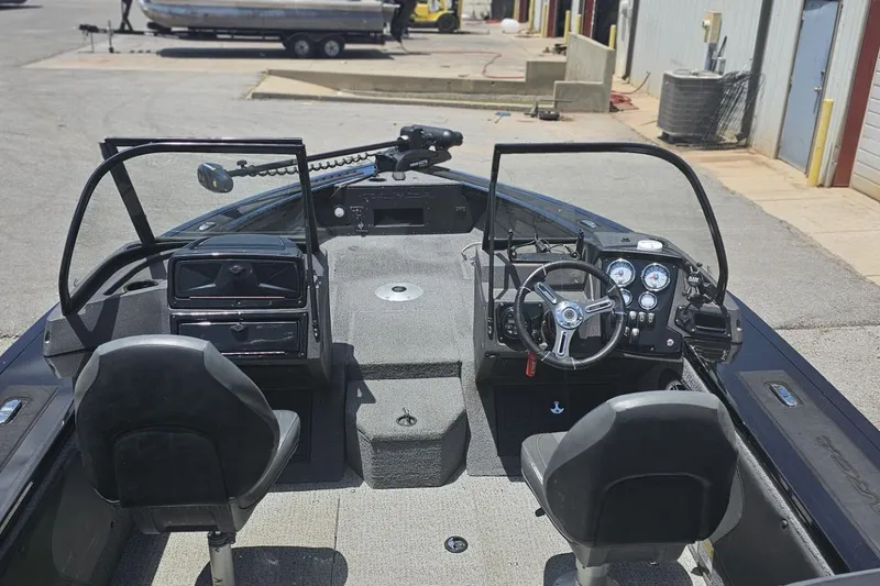 Slide: The Image of 2026 Tracker Targa V-19 Combo boat interior with green navigation light and water bottle. - 8