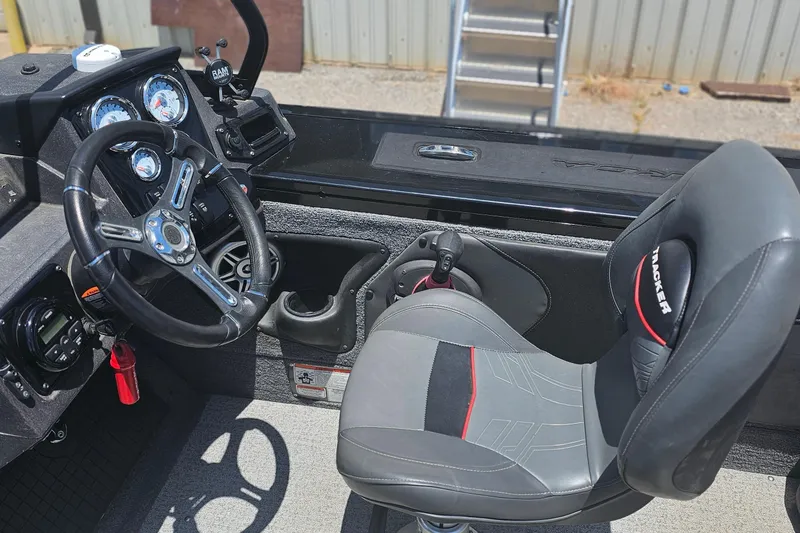 Slide: The Image of 2026 Tracker Targa V-19 Combo boat interior with steering wheel and seat. - 9