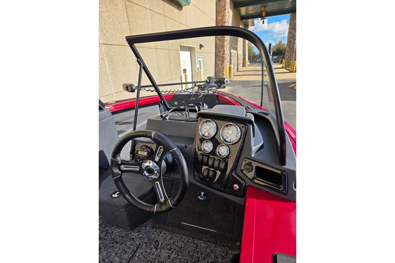 Slide: The Image of 2026 Tracker Targa V-19 Combo boat dashboard with steering wheel and gauges. - 2