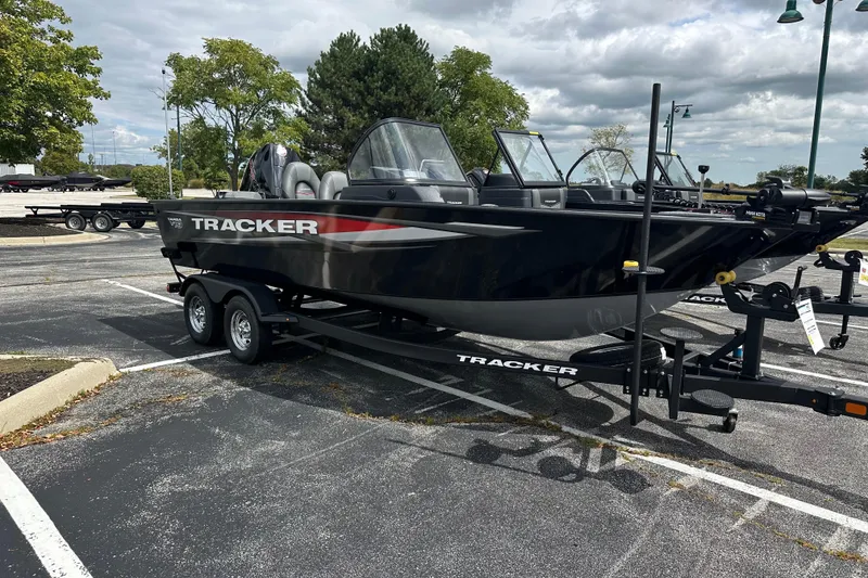 The Image of 2026 Tracker Targa V-19 Combo boat on trailer in parking lot, under cloudy sky. - 1