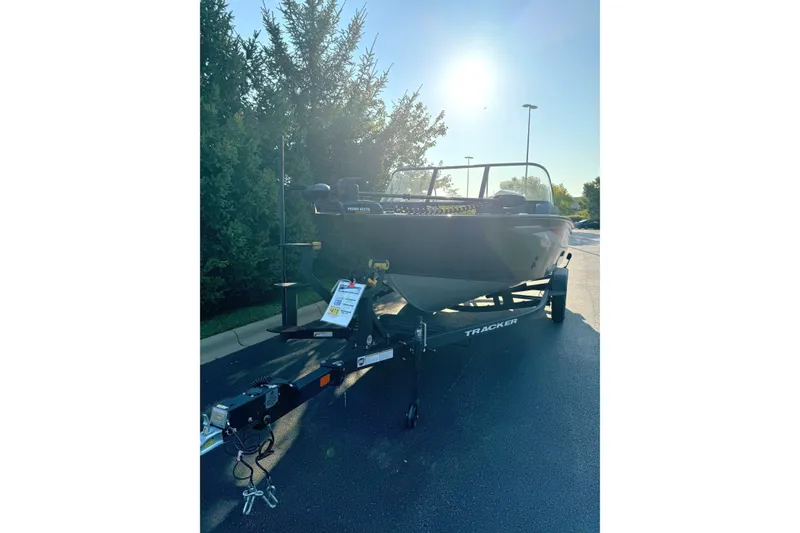 Slide: The Image of 2026 Tracker Targa V-19 Combo boat on trailer, parked outdoors in sunlight. - 2