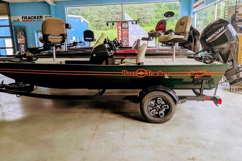 The Image of 2026 Tracker Bass Tracker Classic Limited boat in showroom, featuring Mercury engine. - 0