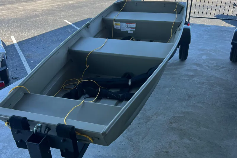Slide: The Image of 2026 Tracker Grizzly 12 Jon boat on trailer, parked outdoors. - 31