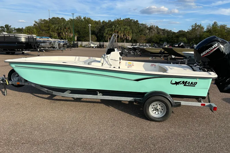 The Image of 2026 Mako Pro Skiff 17 CC boat on trailer, mint green hull, outdoor setting. - 0