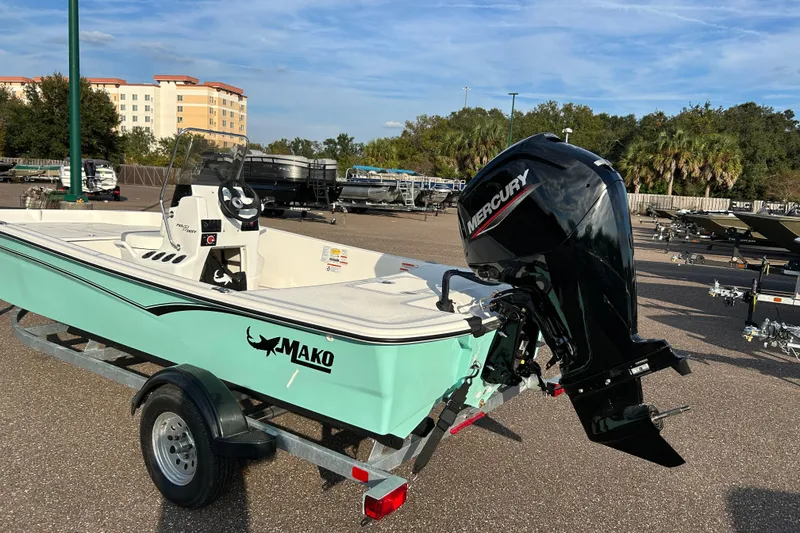 Slide: The Image of 2026 Mako Pro Skiff 17 CC boat with Mercury engine on trailer. - 2