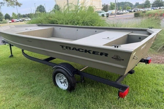 The Image of 2026 Tracker Grizzly 1648 Utility boat on trailer, parked on grass. - 0