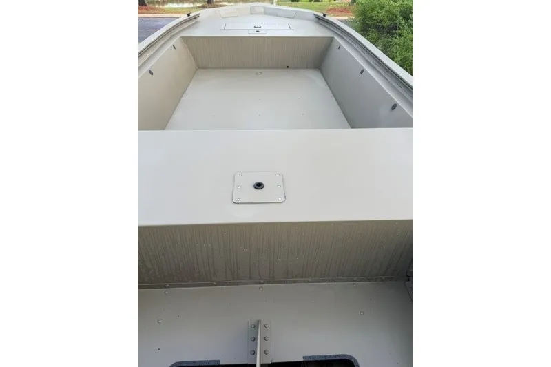 Slide: The Image of 2026 Tracker Grizzly 1648 Utility boat interior, showcasing spacious deck and storage compartments. - 7