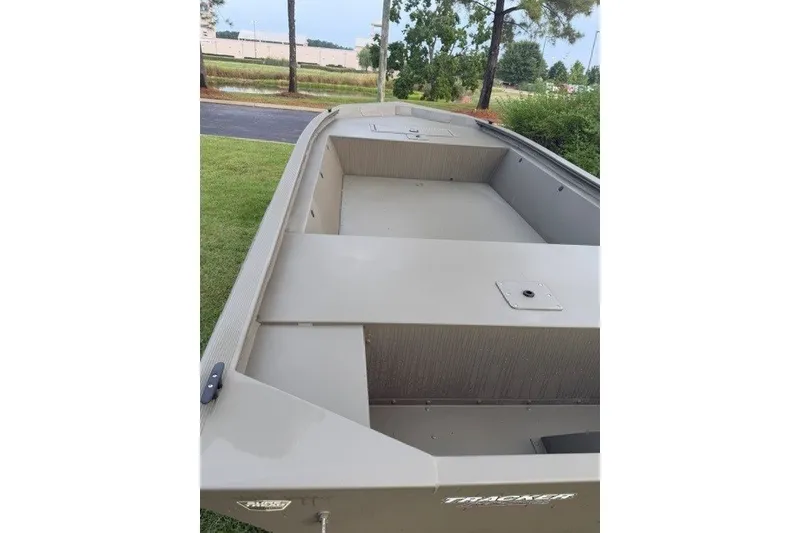 Slide: The Image of 2026 Tracker Grizzly 1648 Utility boat, spacious interior, parked outdoors. - 5