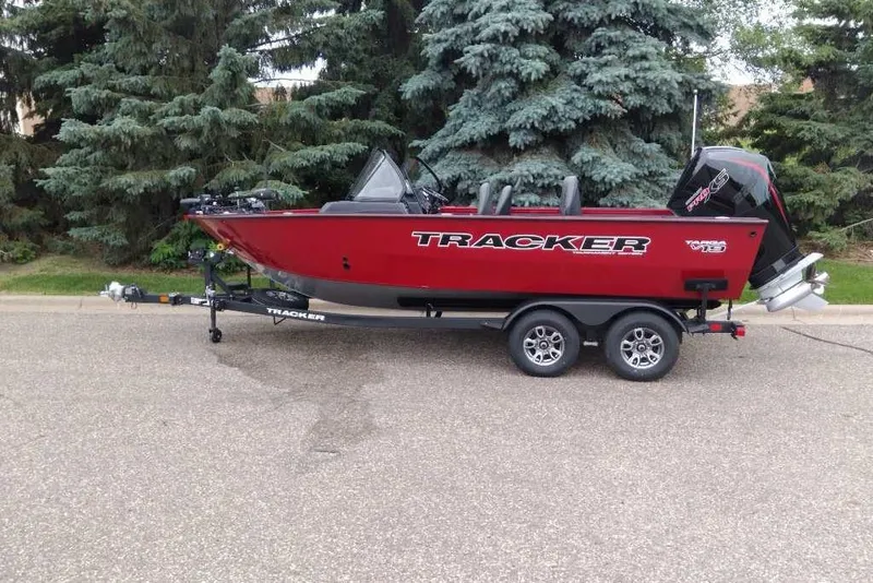 The Image of 2026 Tracker Targa V-19 Combo boat on trailer, parked near trees. - 0