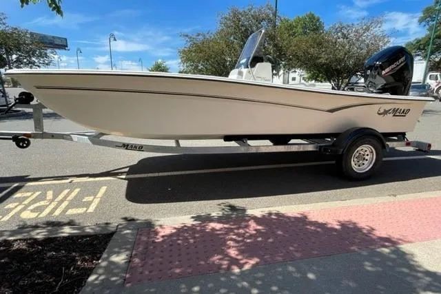 Slide: The Image of 2026 Mako Pro Skiff 17 CC boat on trailer in parking lot. - 1