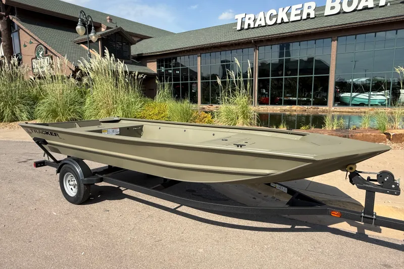 Slide: The Image of 2026 Tracker Grizzly 1754 Utility boat on trailer outside Tracker Boats dealership. - 5