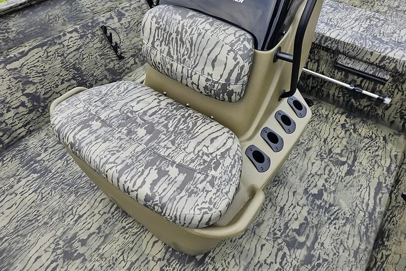 Slide: The Image of 2026 Tracker Grizzly 2072 CC boat interior with camouflage seating and rod holders. - 11
