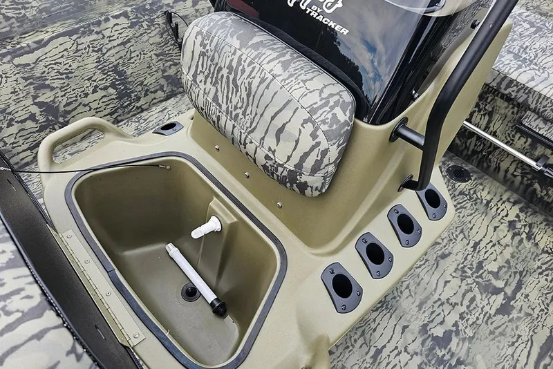 Slide: The Image of 2026 Tracker Grizzly 2072 CC boat interior with camo seating and storage compartment. - 12