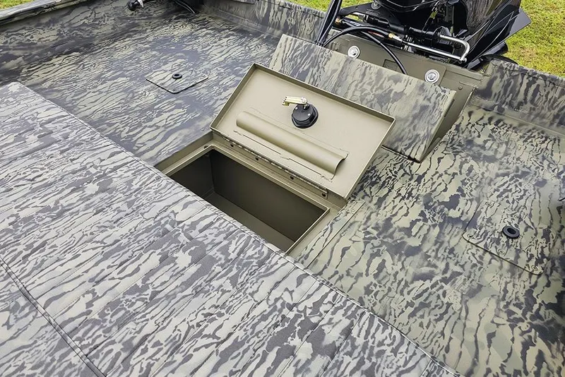 Slide: The Image of 2026 Tracker Grizzly 2072 CC boat with open storage compartment, camo pattern design. - 14