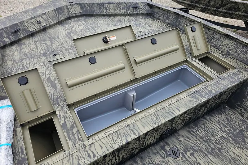 Slide: The Image of 2026 Tracker Grizzly 2072 CC boat storage compartments with camouflage design. - 15