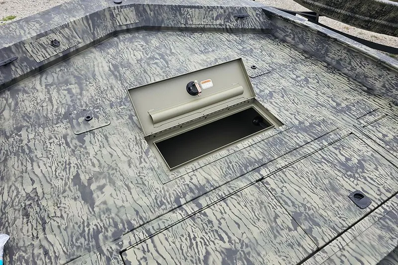 Slide: The Image of 2026 Tracker Grizzly 2072 CC boat deck with open storage compartment. - 16